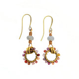 Pair of gold earrings with colorful beads on a white background
